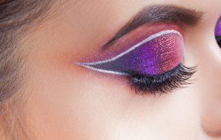 Metallic purple-pink eyeshadow and white eyeliner
