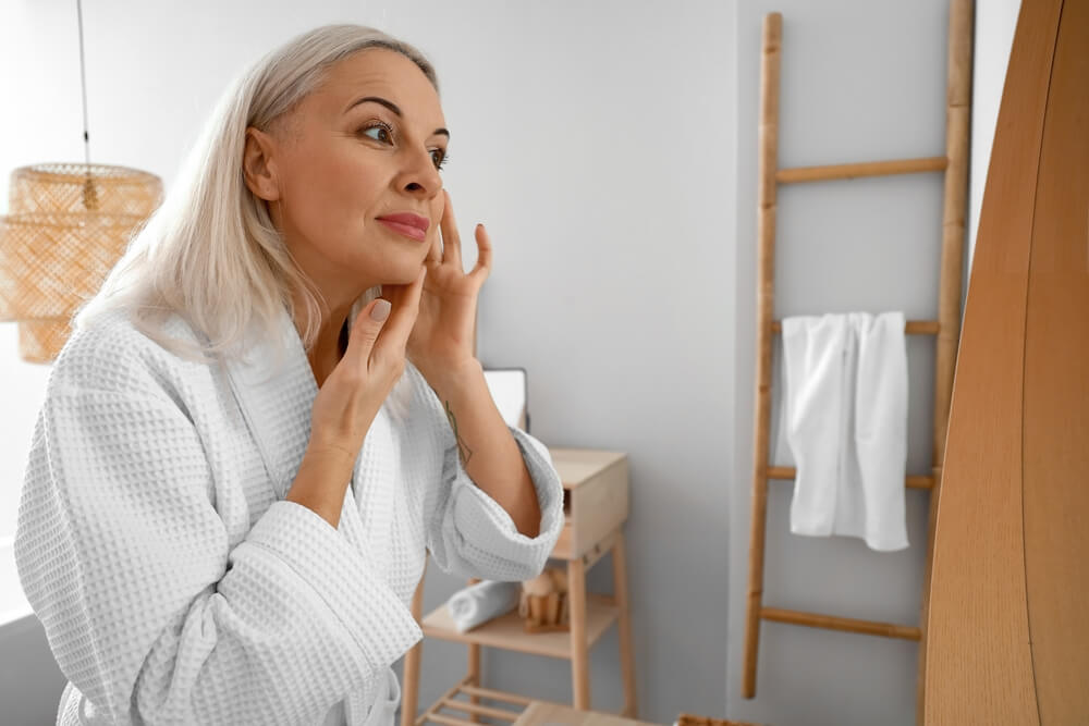 mature woman looking in mirror