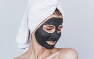 Woman with rosacea using thermal skincare mask