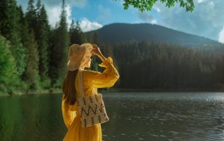 Woman wearing cottagecore fashion trend by lake
