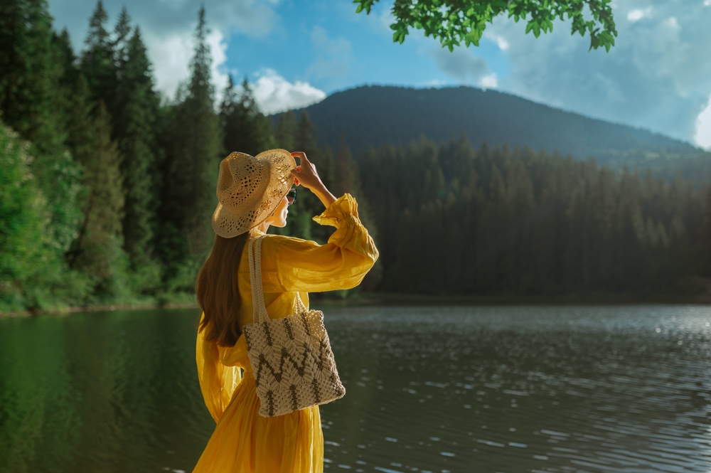 Woman wearing cottagecore fashion trend by lake