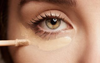 Applying makeup under eyes