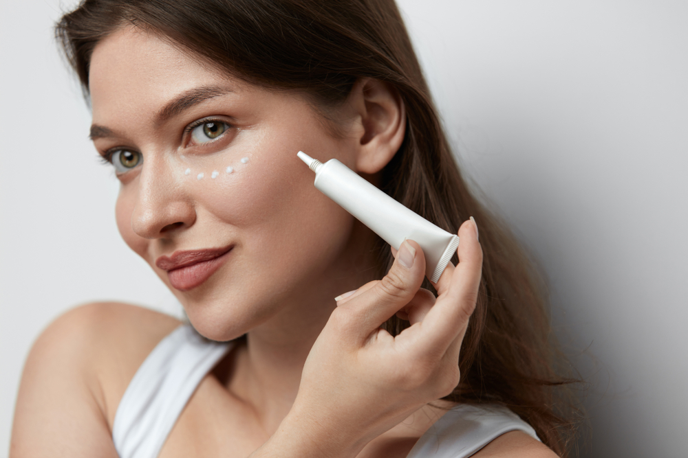 Woman applying eye cream