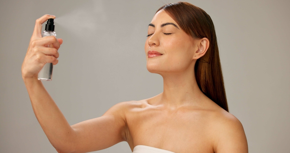 Woman applying setting spray